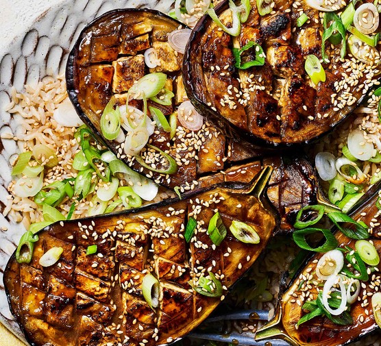 Summer budget meal plan Sticky miso aubergine traybake on a grey plate with sesame seeds