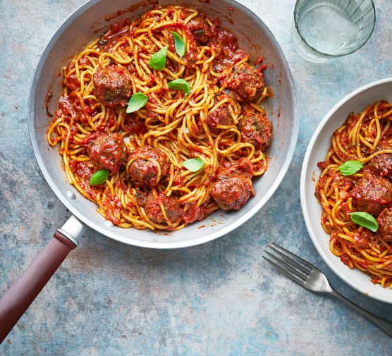 One-pan spaghetti and meatballs A pan of spaghetti and meatballs, with a bowl of spaghetti on the side