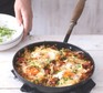 Breakfast hash Breakfast hash in a pan with eggs