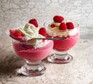 Raspberry mousse Two glasses of raspberry mousse topped with cream and raspberries
