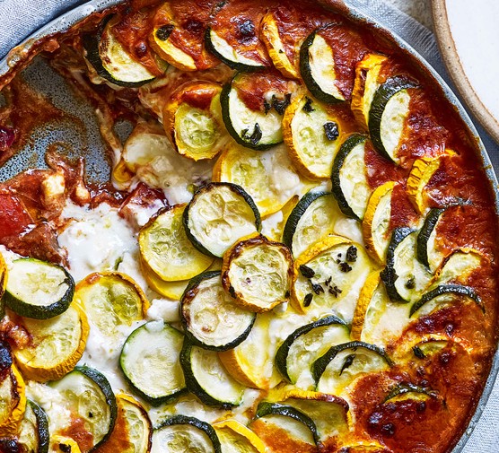 Baked ratatouille & goat’s cheese Ratatouille bake with goat's cheese sauce and layered courgette topping