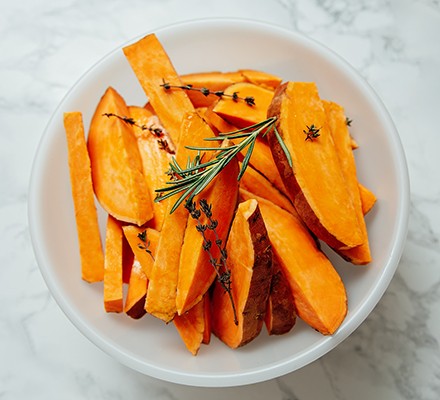 Raw sweet potato wedges in a bowl