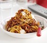 Slow-cooker spaghetti bolognese Bowl of slow-cooker spaghetti bolognese with parmesan cheese and fork
