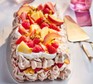 Brown sugar pavlova with fruit Brown sugar pavlova topped with fruit and served on a plate