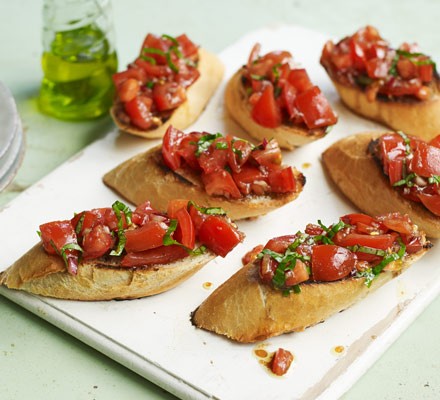 Tomato bruschetta on board with olive oil