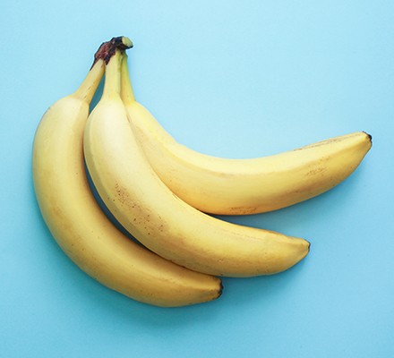 Bunch of bananas on blue background