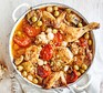 A casserole dish serving chicken Provençal with olives & artichokes