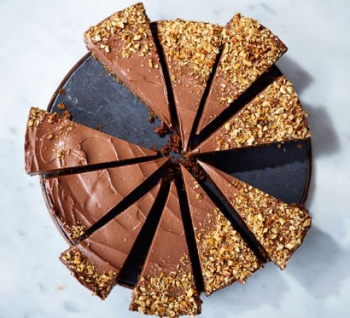 Chocolate cheesecake slices topped with chopped hazelnuts