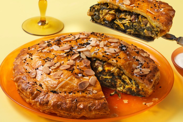 Coronation chicken pie square high res Coronation chicken pie with slice taken out