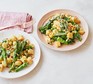 Two plates serving creamy broccoli gnocchi