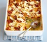 Courgette lasagne in a baking dish with a spoon