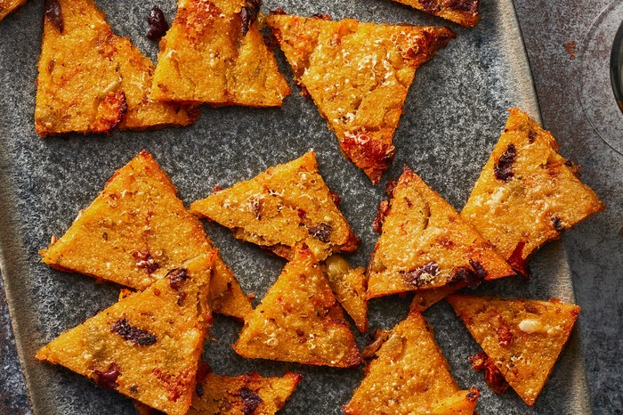 Crisp-parmesan,-olive-&-sundried-tomato-polenta-bites Triangle polenta bites