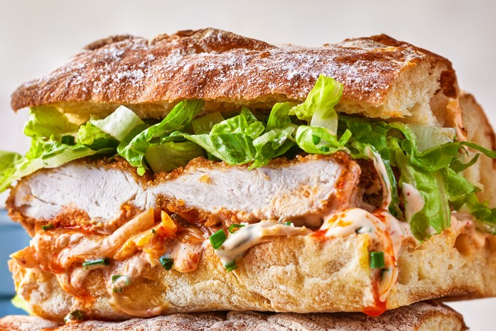 Crispy chilli chicken kimchi mayo sandwich Ciabatta with lettuce, fried chicken and kimchi