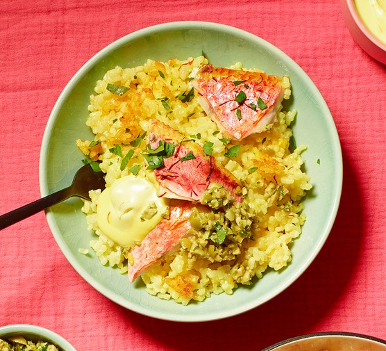 A serving of crispy red mullet rice with saffron aioli & lemon olive salsa