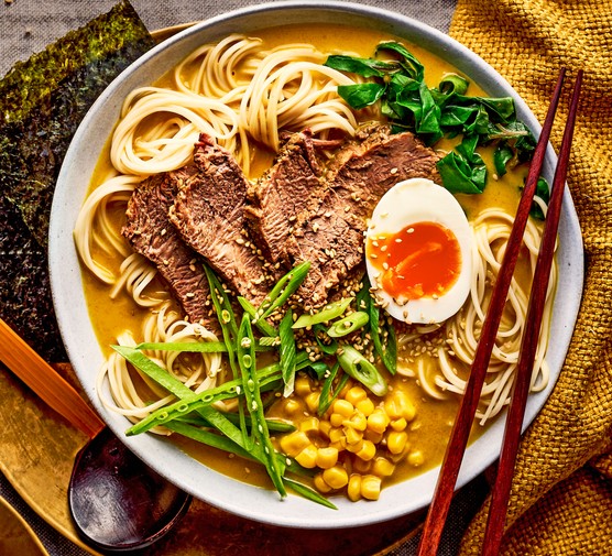 Curried brisket ramen served in a bowl with chopsticks perched