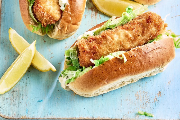 Fish finger hot dogs A fish finger in a hot dog bun with lettuce next to a lemon wedge