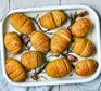 Hasselback potatoes in a baking dish with rosemary