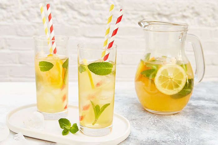 Easy iced tea Two glasses and a jug of iced tea with lemon slices and mint sprigs