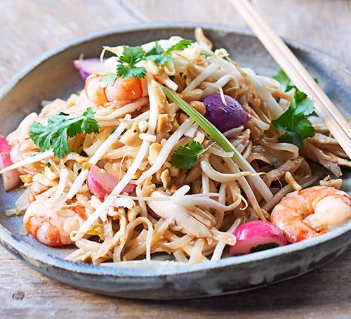 How to use up leftover chicken Chicken pad thai on a plate with chopsticks