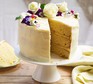 Wedding cake ideas Elderflower & lemon celebration cake served on a cake stand and decorated with fresh flowers