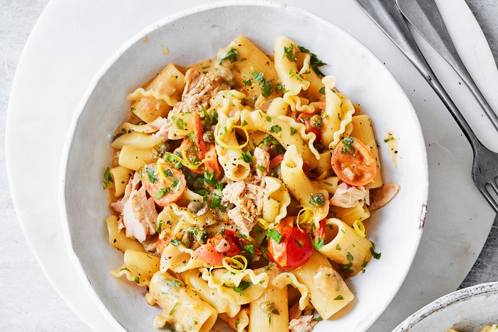 Lemony-tuna,-tomato-&-caper-one-pot-pasta Rigattoni with tuna, tomatoes and capers in a white bowl