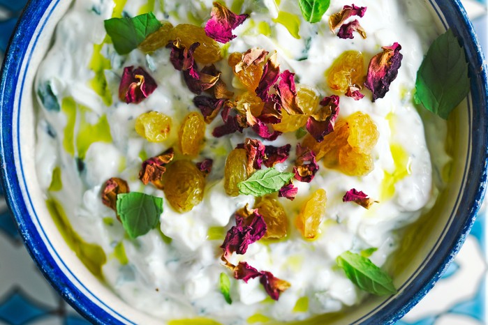 Maast-o-khiar Bowl of yoghurt with cucumber and decorated with petals and mint