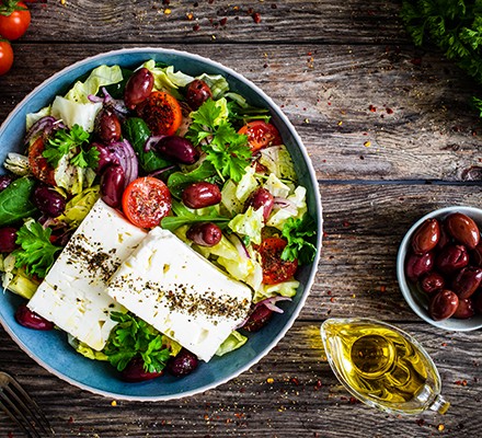 Feta cheese salad on wooden table