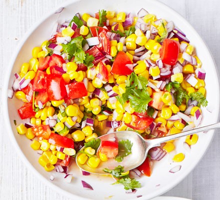A bowl of chopped sweetcorn and tomato salad