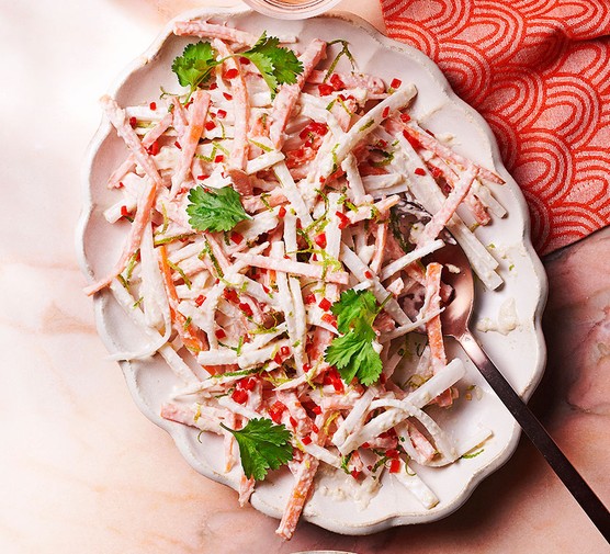 A sharing plate of mooli & carrot salad with zesty cashew dressing