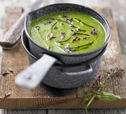 Saucepan of nettle soup topped with nettle flowers