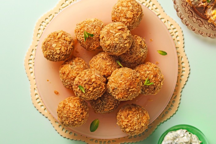 Pea and ham picnic eggs Plate of breaded pea and ham picnic eggs