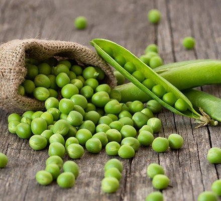 Peas spilling out of a hessian bag