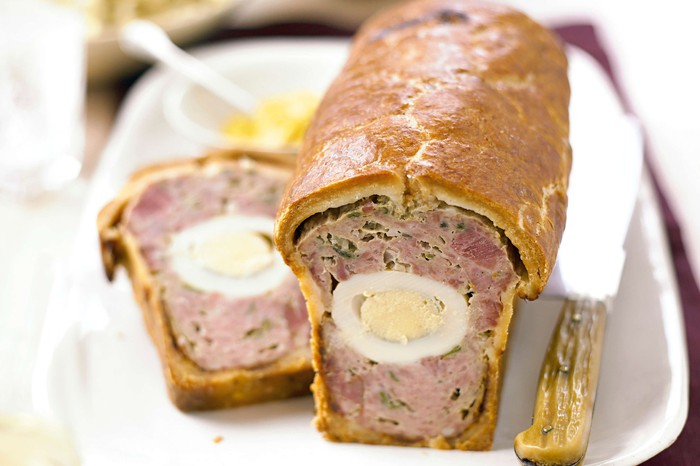 Pork egg & ham pie A picnic-style pork pie with one slice taken off the end