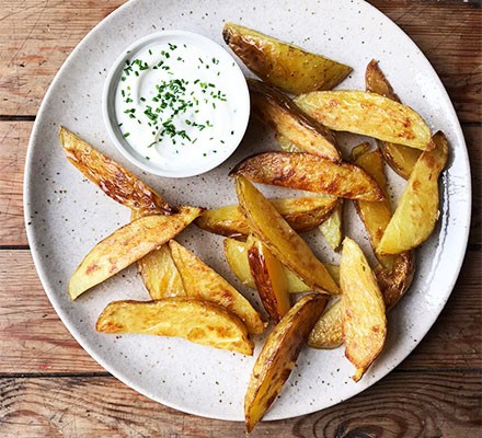 Potato wedges served with soured cream