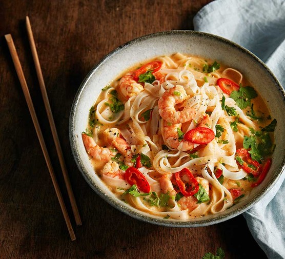 Microwave prawn laksa noodle soup in a bowl with chopsticks