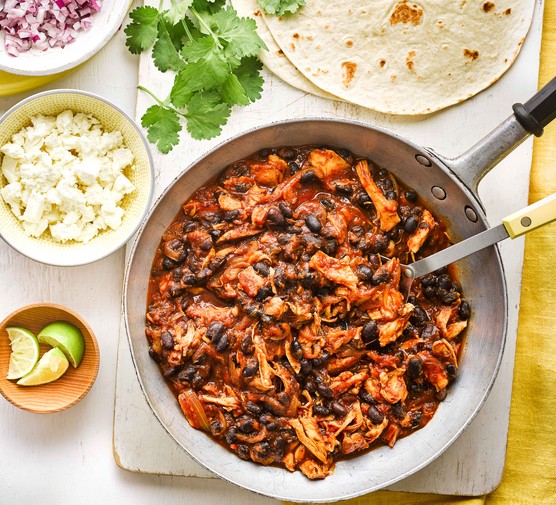 Batch cooking recipes Pan of pulled chicken and black beans with toppings