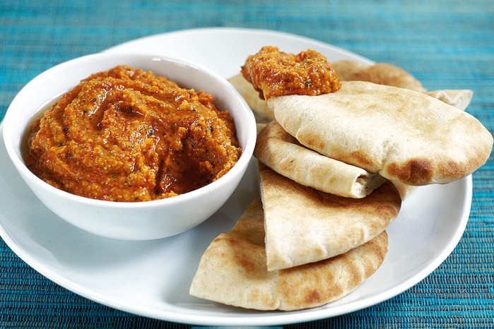 Chickpea and red pepper dip Bowl of red pepper and chickpea dip with pitta bread