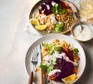 Two servings of roasted harissa red cabbage with coriander & almond bulgur