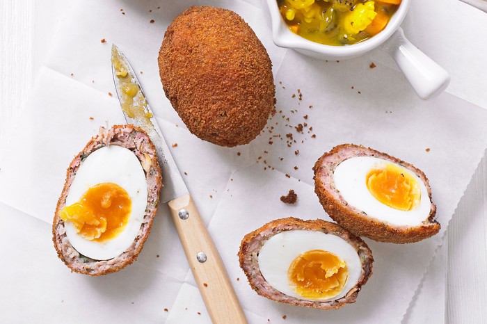 Easy Scotch eggs Scotch eggs, halves and served with pickle