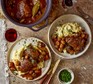 Slow cooker coq au vin A slow cooker and two bowls of coq au vin, served with mash