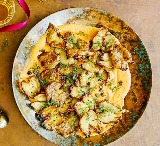 A sharing dish of smashed Jerusalem artichoke with smoky feta & red pepper dip