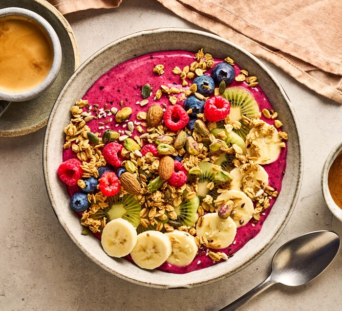 Breakfast ideas Smoothie bowl, topped with fruit and nuts