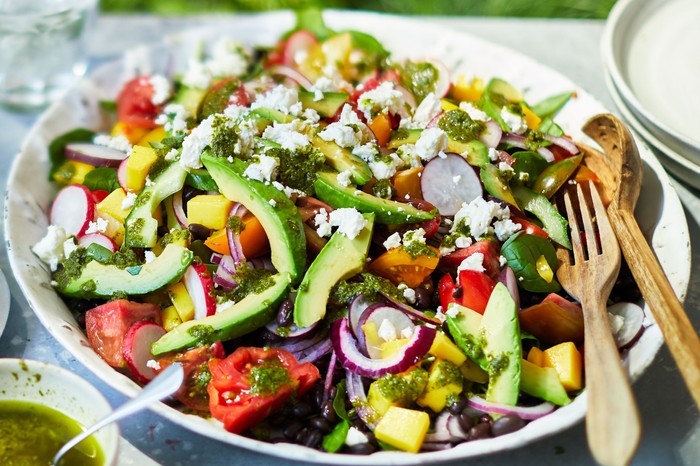 Epic summer salad Plate loaded with colourful tomato avocado, feta salad