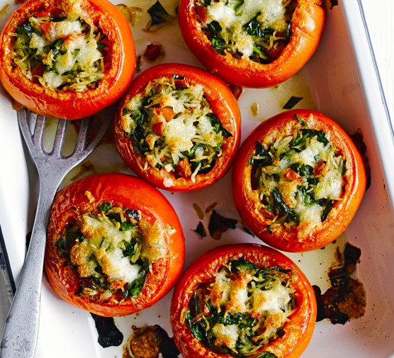 Tomatoes stuffed with pesto rice Tomatoes stuffed with pesto rice in an oven proof dish