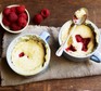 Microwave mug cakes with raspberries on a tea-towel