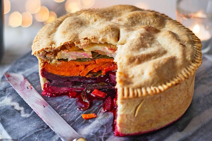 Vegan pie Vegan pie cut open to reveal colourful layered veg