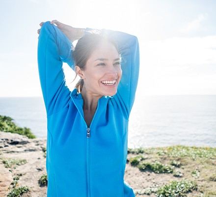 Happy woman stretching on a run