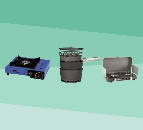 three camping stoves on a green background